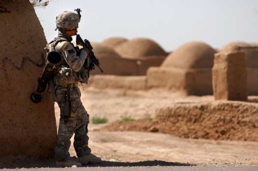 A U.S. Army Private First Class with 782nd Alpha Company pulls perimeter security while other soldiers from his company deliver school supplies and conduct counterinsurgency operations, March 31, 2010, Morgan Kacha village, Southern Afghanistan. School supplies were handed out by ANA soldiers, while troop leaders talked with the village elders. (U.S. Air Force photo by Senior Airman Kenny Holston)